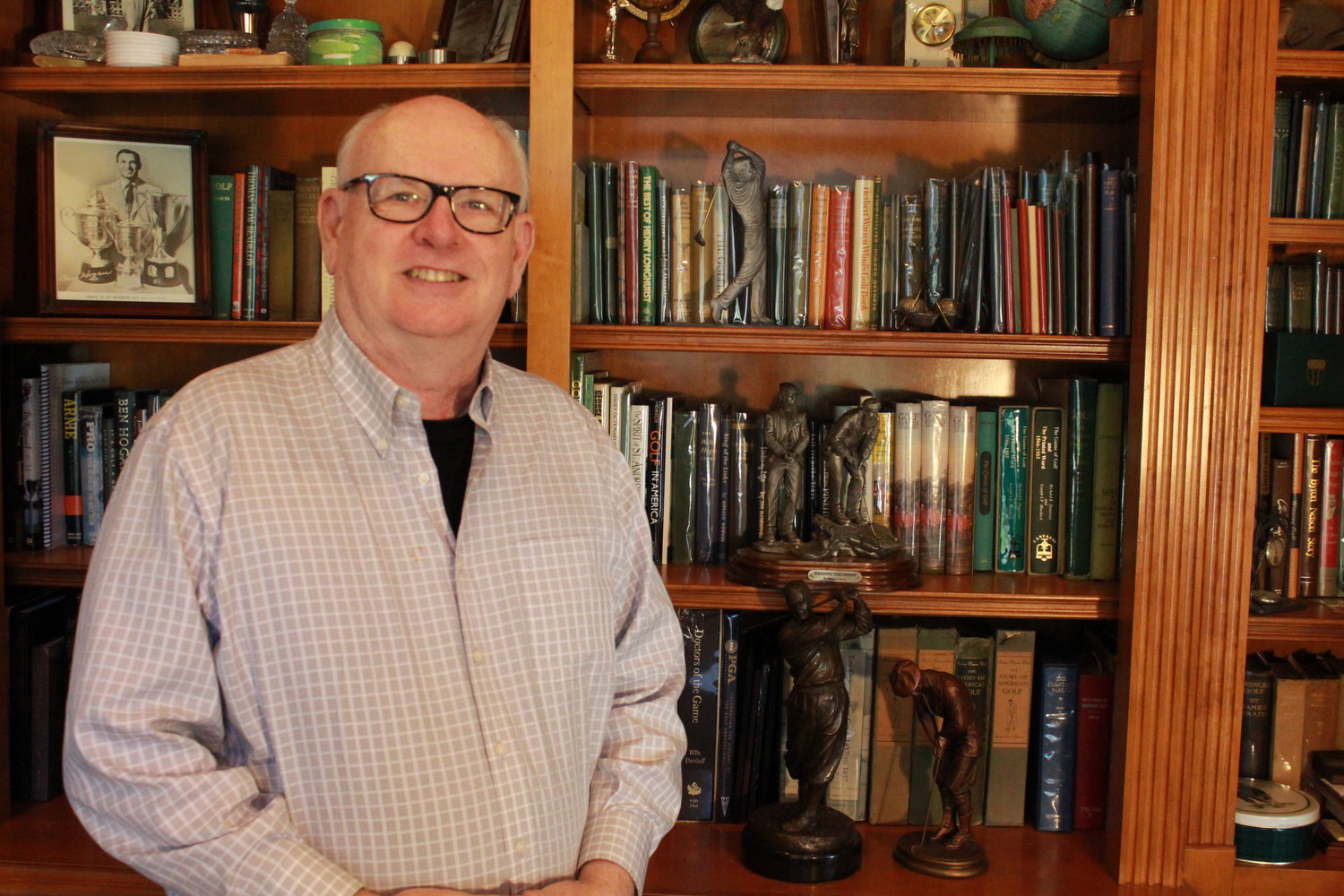 Billy Dettlaff stands in his study, surrounded by golf memorabilia. He started the first chapter of The American Golf Memories Project in Ponte Vedra Beach as his way of “giving back to the game.”